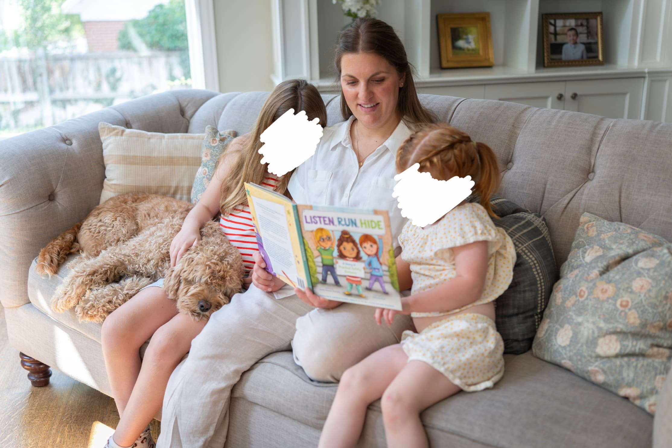 Emily Romrell reading Listen Run Hide to her children on the couch